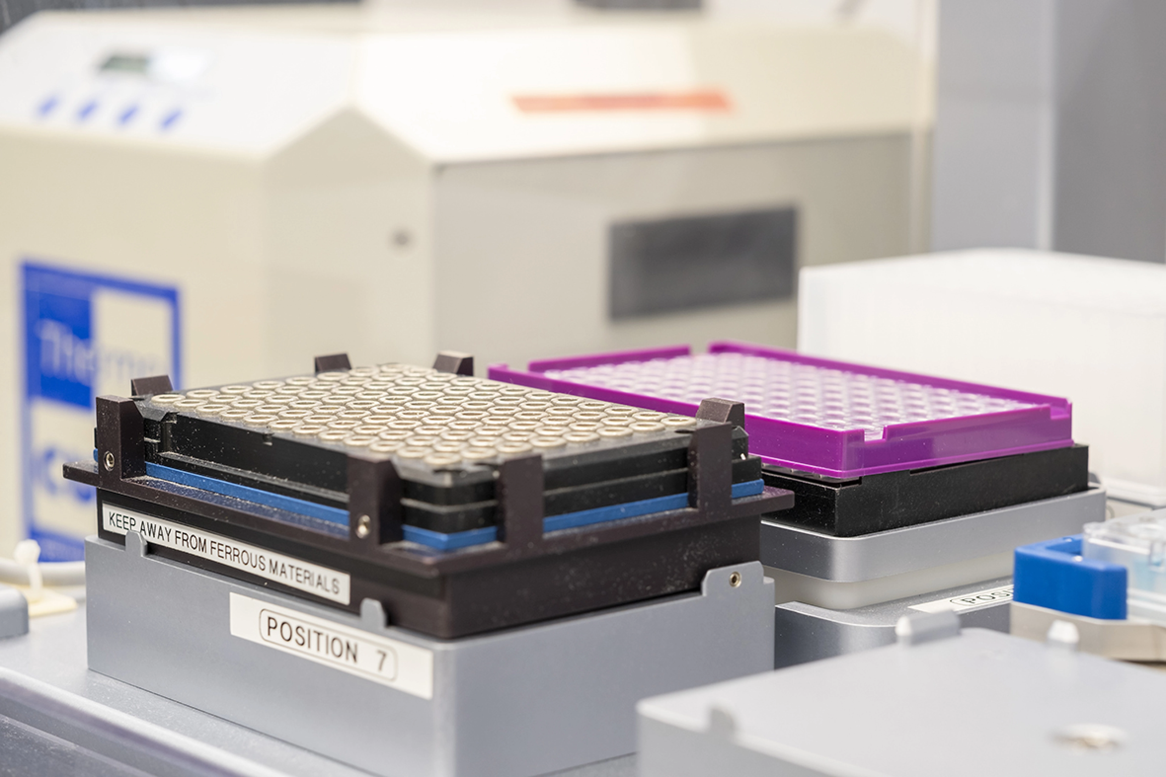 Close-up of a purple and black plate in robotic system.