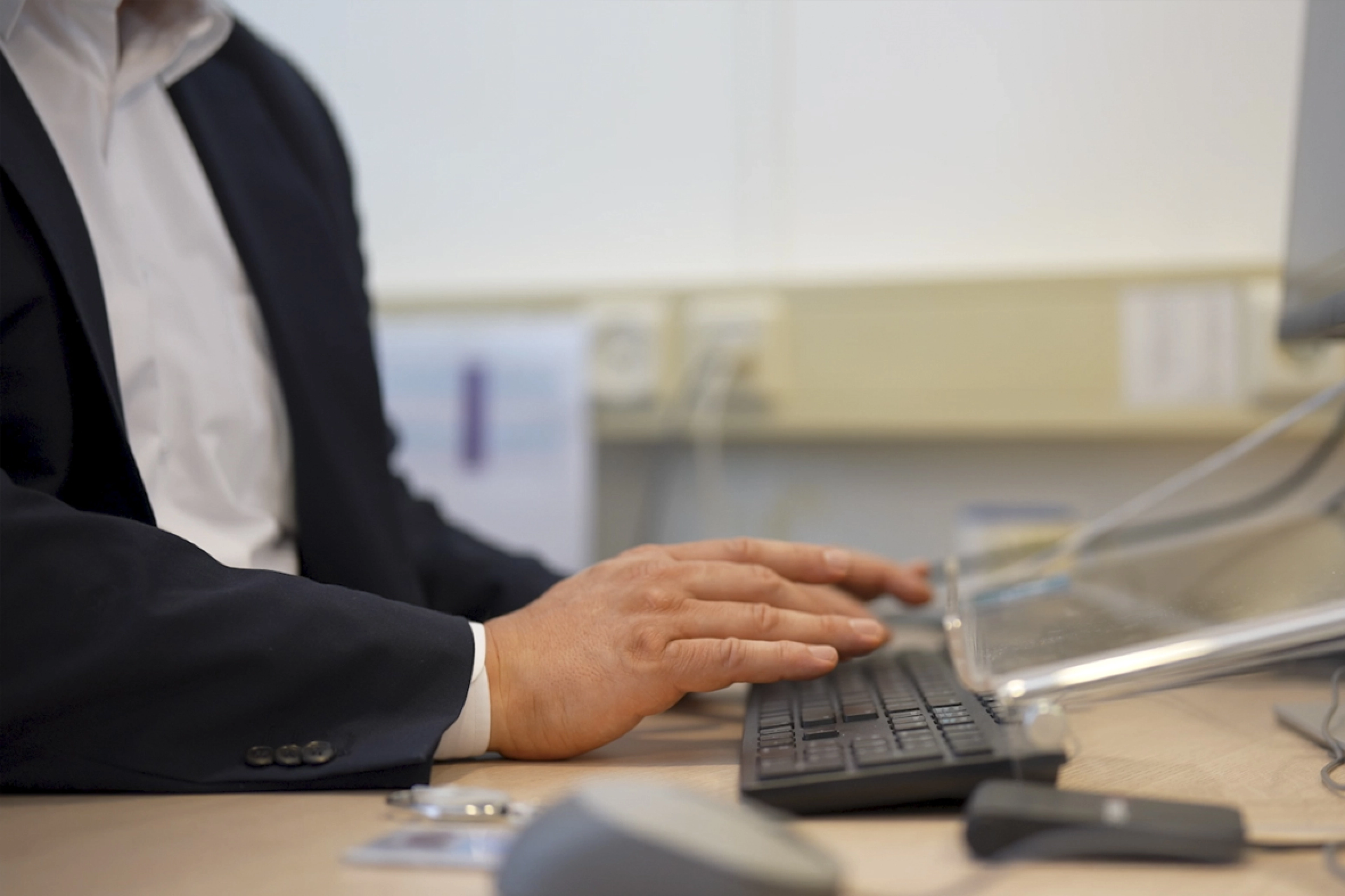 Close-up of male hands on a keyboard.