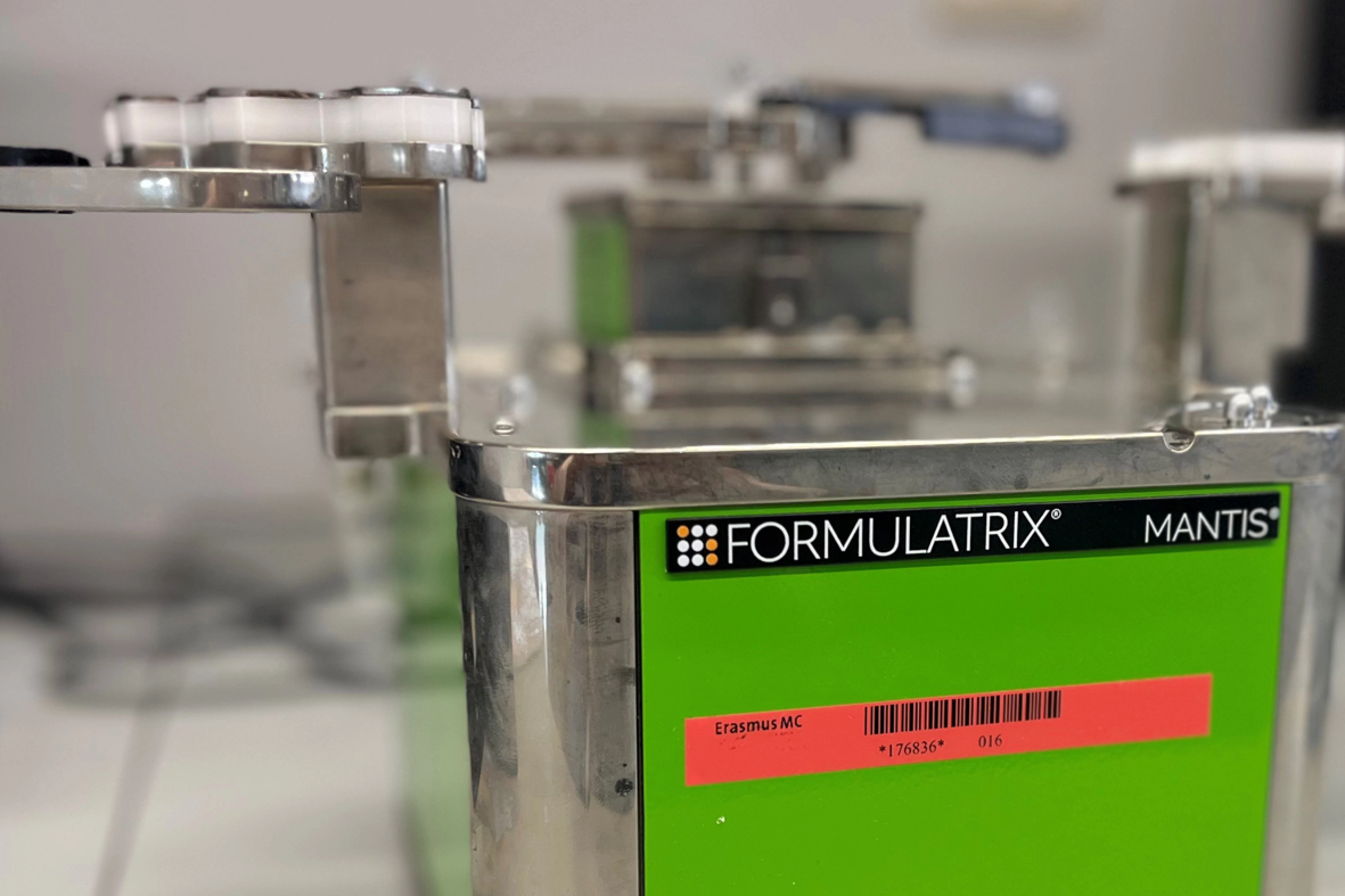 A close-up of the Formulatrix Mantis with green front and orange sticker.