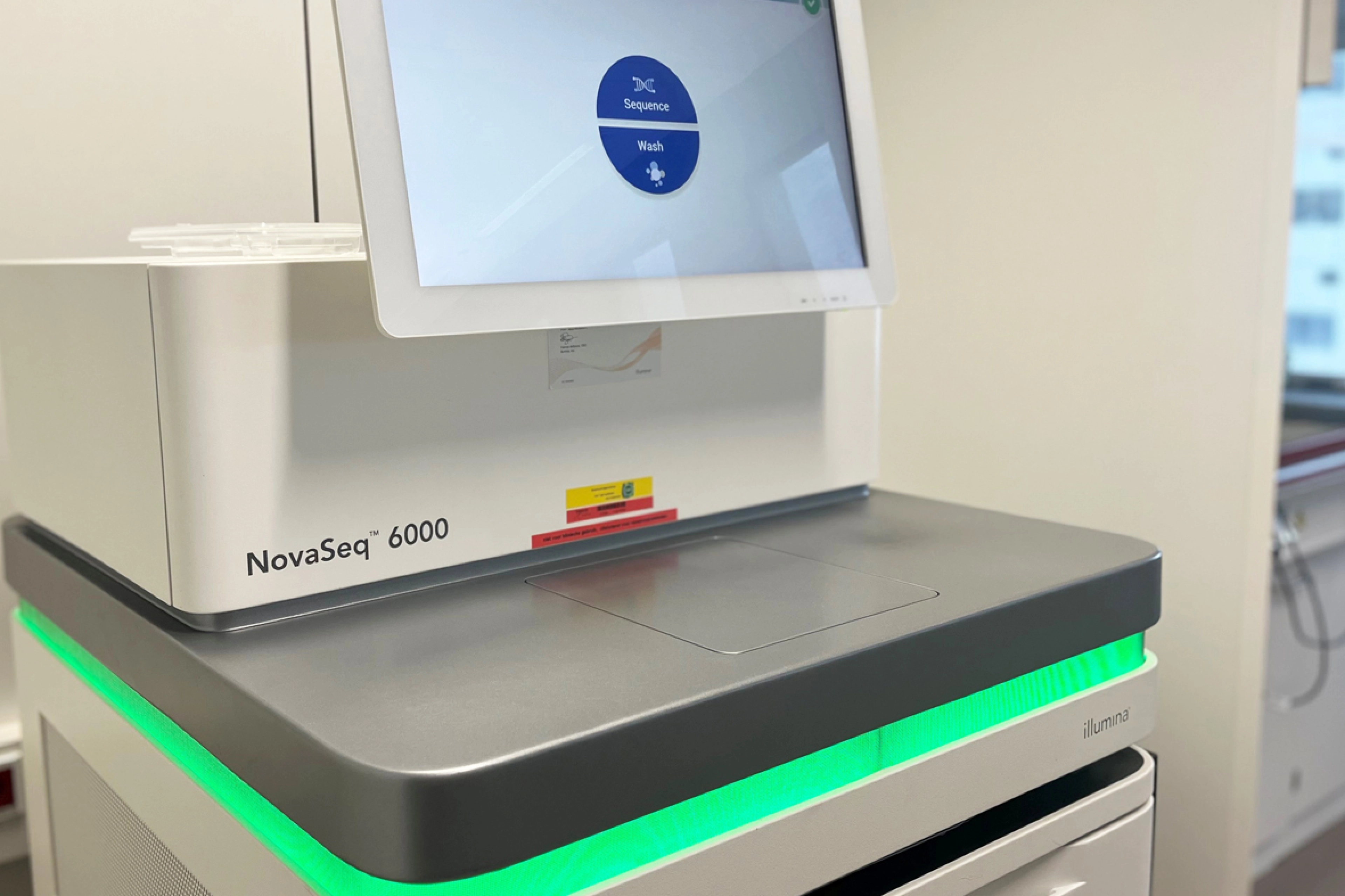Close-up of NovaSeq 6000 sequencer with green light.