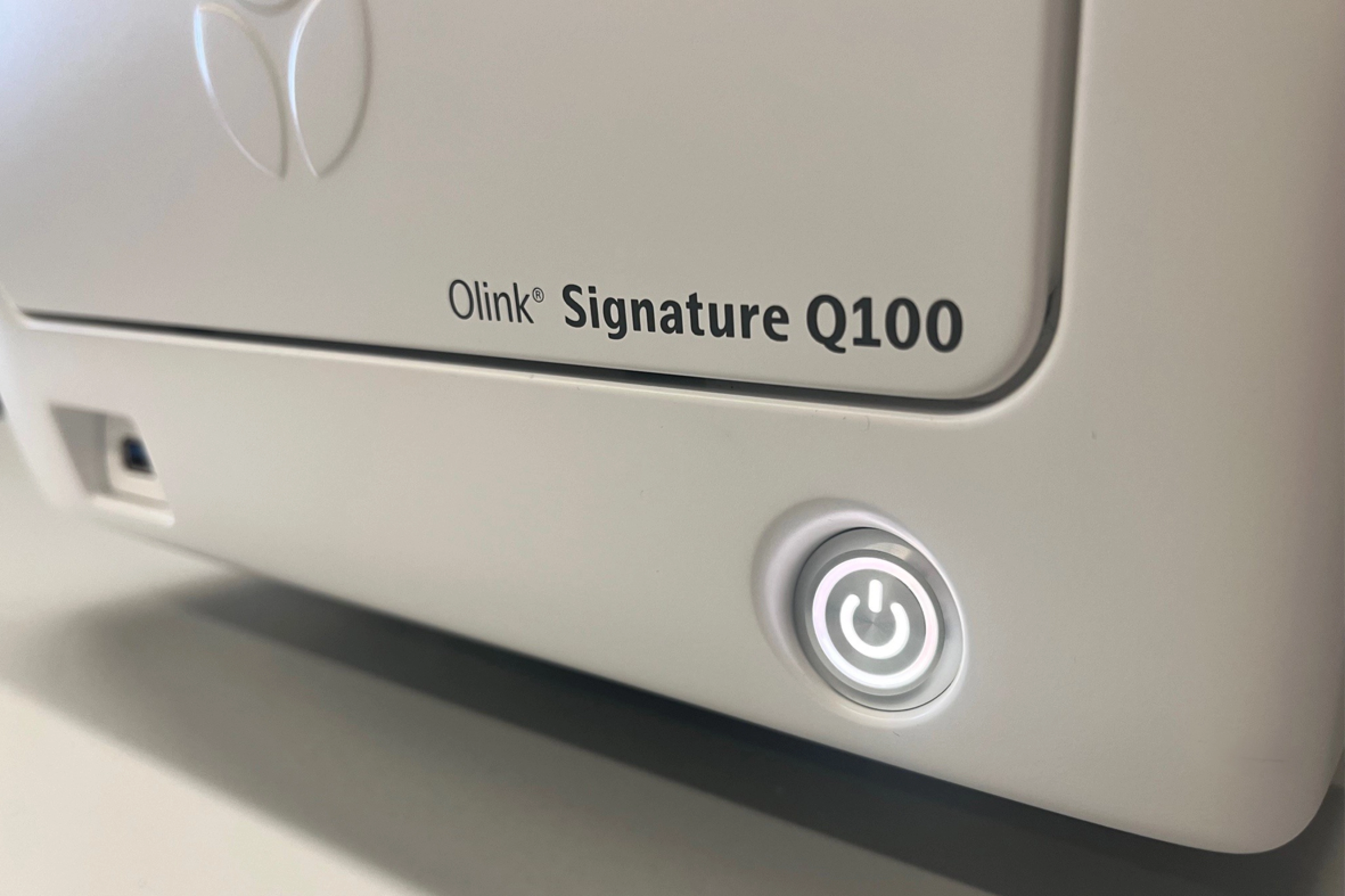 Close-up of Olink Signature instrument, a laboratory device used for protein biomarker analysis.